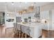 Bright, modern kitchen with stainless steel appliances, an island with seating, and stylish pendant lighting at 4824 Benito Ct, Bradenton, FL 34211