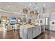A shot of an open-concept kitchen with an island, modern lighting, stainless appliances, and hardwood floors at 4824 Benito Ct, Bradenton, FL 34211