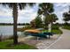 Scenic lake view with canoes, walking path, and gazebo in the community at 4824 Benito Ct, Bradenton, FL 34211