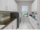 Spacious laundry room with modern appliances, ample storage, and natural light at 4824 Benito Ct, Bradenton, FL 34211