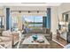 Sophisticated living room featuring comfortable seating, a decorative rug, and beautiful lake views at 4824 Benito Ct, Bradenton, FL 34211