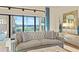Elegant living room showcasing a tufted sofa, stylish decor, and large windows with lake views at 4824 Benito Ct, Bradenton, FL 34211