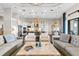 Open-concept living room with stylish furniture and a view into the modern kitchen at 4824 Benito Ct, Bradenton, FL 34211