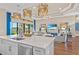 Bright, open-concept living room features elegant lighting, hardwood floors, and views of the lake at 4824 Benito Ct, Bradenton, FL 34211