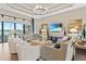 Spacious living room with hardwood floors, stylish furniture, a decorative ceiling, and large sliding glass doors at 4824 Benito Ct, Bradenton, FL 34211
