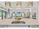 Spacious open floorplan with large kitchen island and living room with chandelier lighting at 4824 Benito Ct, Bradenton, FL 34211
