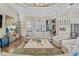 Elegant living room with tray ceiling, hardwood floors, stylish furniture, and a beautiful chandelier at 4824 Benito Ct, Bradenton, FL 34211