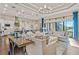 Open concept living room with modern lighting, elegant furniture, and a view of the kitchen and dining area at 4824 Benito Ct, Bradenton, FL 34211