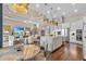 Open concept living and kitchen area with an island, modern lighting, stainless appliances, and hardwood floors at 4824 Benito Ct, Bradenton, FL 34211