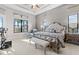 Bright main bedroom offering a tray ceiling, water view, and access to the balcony at 4824 Benito Ct, Bradenton, FL 34211