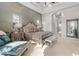 Elegant main bedroom featuring a tufted headboard, tray ceiling, and natural light at 4824 Benito Ct, Bradenton, FL 34211