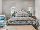 Close-up of the primary bedroom with a tufted headboard and decorative pillows at 4824 Benito Ct, Bradenton, FL 34211