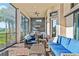 Covered patio with ample seating, featuring an outdoor kitchen and scenic lake views at 4824 Benito Ct, Bradenton, FL 34211