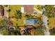 Aerial view outlining property with a pool and mature landscaping at 5912 N Lynn Ave, Tampa, FL 33604