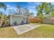 Backyard featuring a patio, grass and the enclosed porch at 5912 N Lynn Ave, Tampa, FL 33604
