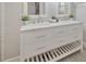 Bathroom vanity features double sinks, white marble countertop, and white cabinets with stylish silver pulls at 5912 N Lynn Ave, Tampa, FL 33604