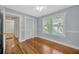 Charming bedroom offers wood floors, two windows, closet and a view of hallway through a doorway at 5912 N Lynn Ave, Tampa, FL 33604