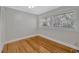 Cozy bedroom with hardwood floors, two windows, and built-in closet provides ample storage at 5912 N Lynn Ave, Tampa, FL 33604