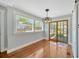 Dining room with wood floors and sliding doors to the screened-in porch at 5912 N Lynn Ave, Tampa, FL 33604