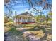 Charming two-story home featuring a lush landscaped yard with mature trees at 5912 N Lynn Ave, Tampa, FL 33604