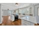 Well-lit kitchen with white cabinets, stainless steel appliances, and stylish countertops at 5912 N Lynn Ave, Tampa, FL 33604