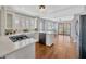 Updated kitchen featuring white cabinetry, modern appliances, and an open layout at 5912 N Lynn Ave, Tampa, FL 33604