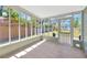 Enclosed porch featuring views of the backyard and a screen door at 5912 N Lynn Ave, Tampa, FL 33604