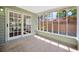 Screened porch with tile floor and sliding door access to the interior at 5912 N Lynn Ave, Tampa, FL 33604