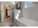 Bright bathroom with a white soaking tub and stylish mosaic tile flooring at 604 W Hilda St, Tampa, FL 33603