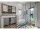 Modern bathroom featuring a double sink vanity, a soaking tub, and a glass-enclosed shower at 604 W Hilda St, Tampa, FL 33603