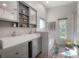 Stylish bathroom with a modern double sink vanity, a soaking tub, and a glass-enclosed shower at 604 W Hilda St, Tampa, FL 33603