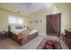 Sunny bedroom with a rustic barn door, comfortable bed, and ample natural light at 604 W Hilda St, Tampa, FL 33603