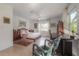 Bright bedroom features a bed, desk area, and windows offering natural light at 604 W Hilda St, Tampa, FL 33603