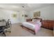 Sunlit bedroom featuring a bed, writing desk, and light cork flooring at 604 W Hilda St, Tampa, FL 33603