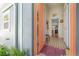 Inviting entryway with colorful tile flooring and bright orange door offers a warm welcome at 604 W Hilda St, Tampa, FL 33603