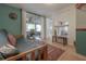 Cozy living room with a futon and large sliding glass doors to the covered porch at 604 W Hilda St, Tampa, FL 33603
