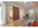 Bright living room with a rustic barn door, wood floors, and natural light from two windows at 604 W Hilda St, Tampa, FL 33603