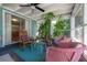 Relaxing porch featuring comfortable seating, vibrant plants, and screened windows for enjoying the outdoors at 604 W Hilda St, Tampa, FL 33603