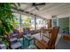 Charming porch with dining and seating areas, offering a perfect blend of comfort and nature views at 604 W Hilda St, Tampa, FL 33603