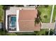 Aerial view highlighting the roof, screened-in pool, brick-paved backyard, and manicured lawn at 6716 Frontier Ln, Tampa, FL 33625
