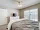 Cozy bedroom featuring a ceiling fan and a white dresser with a television set, offering a relaxing space at 6716 Frontier Ln, Tampa, FL 33625