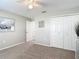 Cozy bedroom with neutral carpet, a ceiling fan, and closet at 6716 Frontier Ln, Tampa, FL 33625