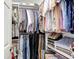 Organized walk-in closet with hanging clothes and folded items, maximizing storage space in this home at 6716 Frontier Ln, Tampa, FL 33625