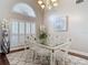 Bright dining room with shuttered windows, elegant lighting, and seating for six at 6716 Frontier Ln, Tampa, FL 33625