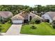 Charming single-story home with well-manicured lawn, lush landscaping, and inviting curb appeal at 6716 Frontier Ln, Tampa, FL 33625