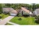 Charming single-story home with a well-manicured lawn, lush landscaping, and inviting curb appeal at 6716 Frontier Ln, Tampa, FL 33625