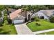 Charming single-story home with a well-manicured lawn, lush landscaping, and an inviting curb appeal at 6716 Frontier Ln, Tampa, FL 33625