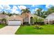 Charming single-story home with manicured lawn, lush landscaping, and inviting curb appeal at 6716 Frontier Ln, Tampa, FL 33625