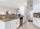 Spacious open-concept kitchen featuring granite countertops and stylish white cabinetry at 6716 Frontier Ln, Tampa, FL 33625