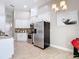 Bright kitchen featuring stainless steel appliances, white cabinets, and granite countertops at 6716 Frontier Ln, Tampa, FL 33625